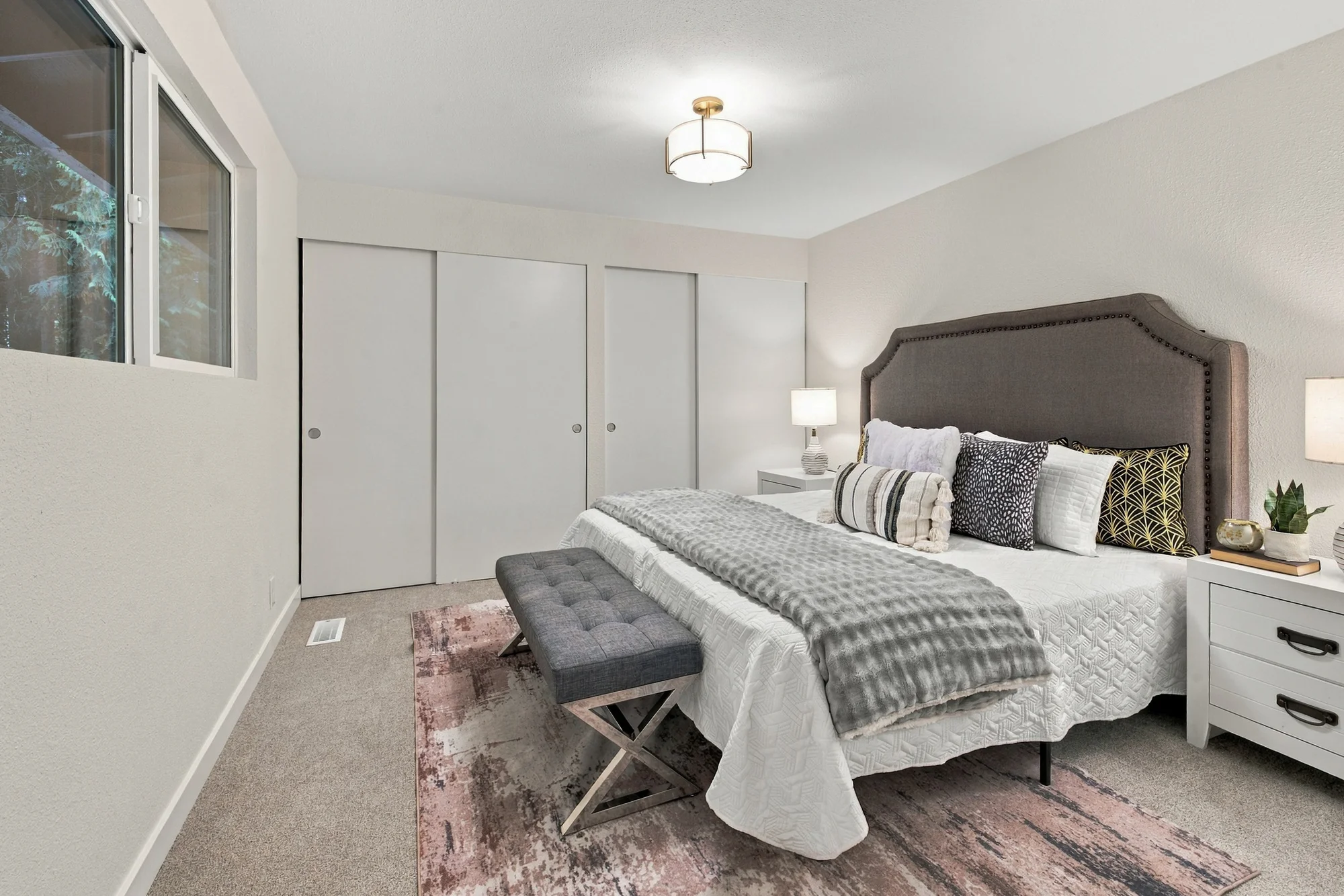 Upstairs primary bedroom with evergreen views